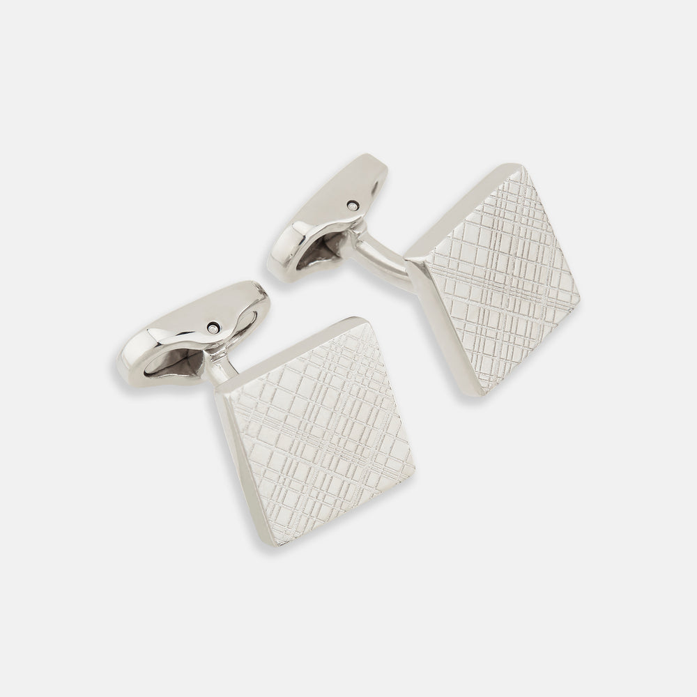 Turnbull & Asser’s Silver Grid Square Cufflinks feature a geometric crisscross pattern in sterling silver, adding refined elegance to any look.