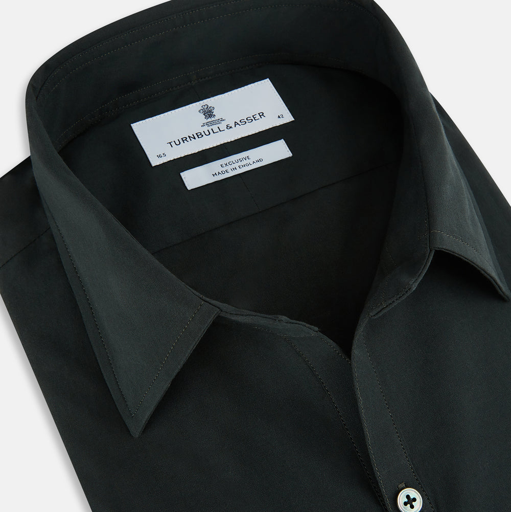 The FOREST GREEN WINDSOR SHIRT by Turnbull & Asser features long sleeves, a Windsor collar, and buttoned cuffs, exemplifying British craftsmanship. Displayed on a plain white background.