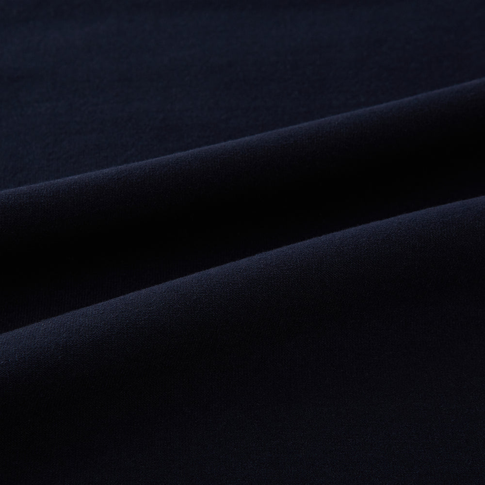 A navy short-sleeve pyjama shirt by Turnbull & Asser is laid flat on a white background, featuring a round neckline and a minimalist design—perfect for relaxed wear.
