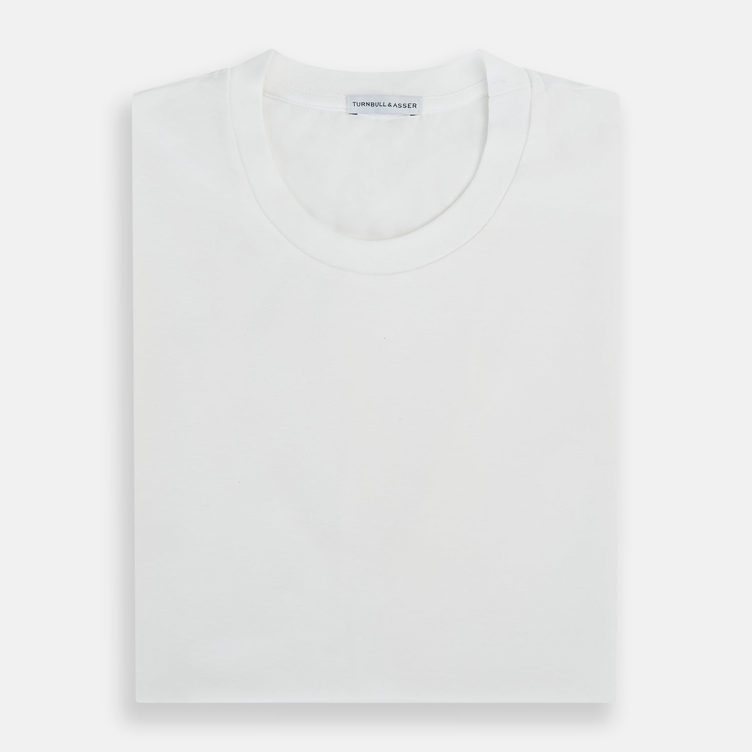 View 5 of product The Turnbull & Asser White Short-sleeve Pyjama Shirt is shown laid flat on a white background, featuring a plain, logo-free design for effortless comfort and classic loungewear style.