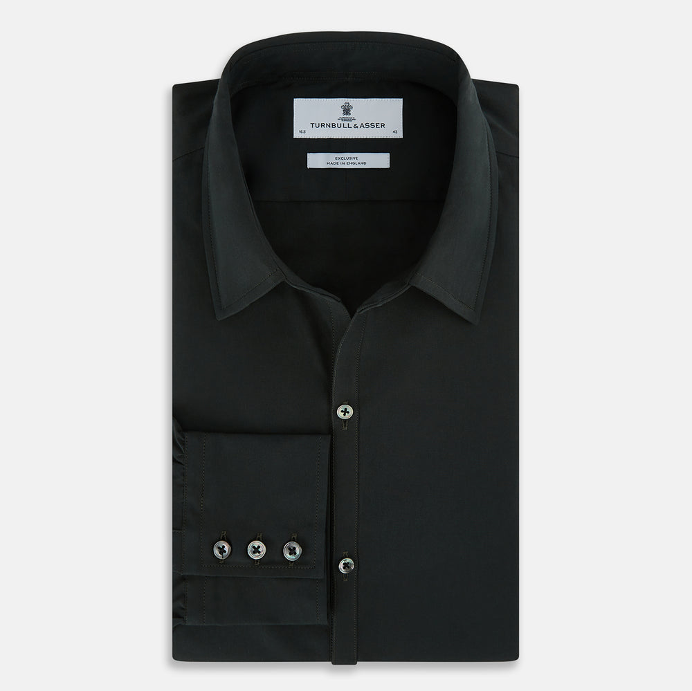The FOREST GREEN WINDSOR SHIRT by Turnbull & Asser features long sleeves, a Windsor collar, and buttoned cuffs, exemplifying British craftsmanship. Displayed on a plain white background.