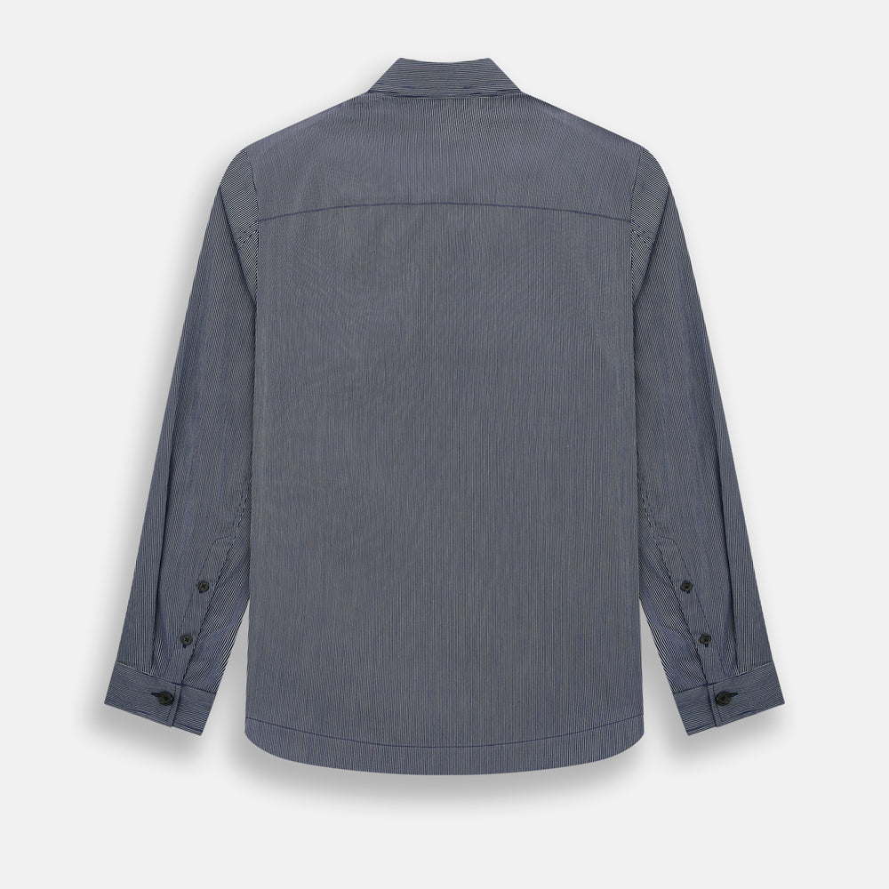 The Navy Stripe Highbury Overshirt by Turnbull & Asser features thin vertical stripes, black buttons, a collar, and a chest pocket. Displayed on a plain white background, it’s inspired by classic Turnbull & Asser style.