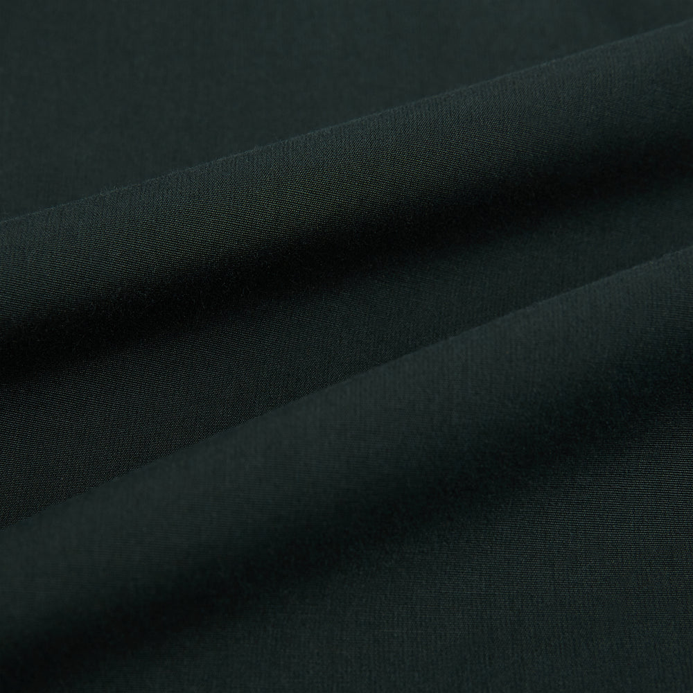 The FOREST GREEN WINDSOR SHIRT by Turnbull & Asser features long sleeves, a Windsor collar, and buttoned cuffs, exemplifying British craftsmanship. Displayed on a plain white background.