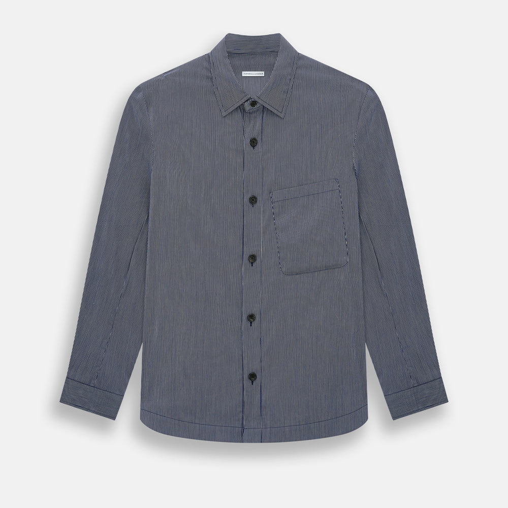The Navy Stripe Highbury Overshirt by Turnbull & Asser features thin vertical stripes, black buttons, a collar, and a chest pocket. Displayed on a plain white background, it’s inspired by classic Turnbull & Asser style.