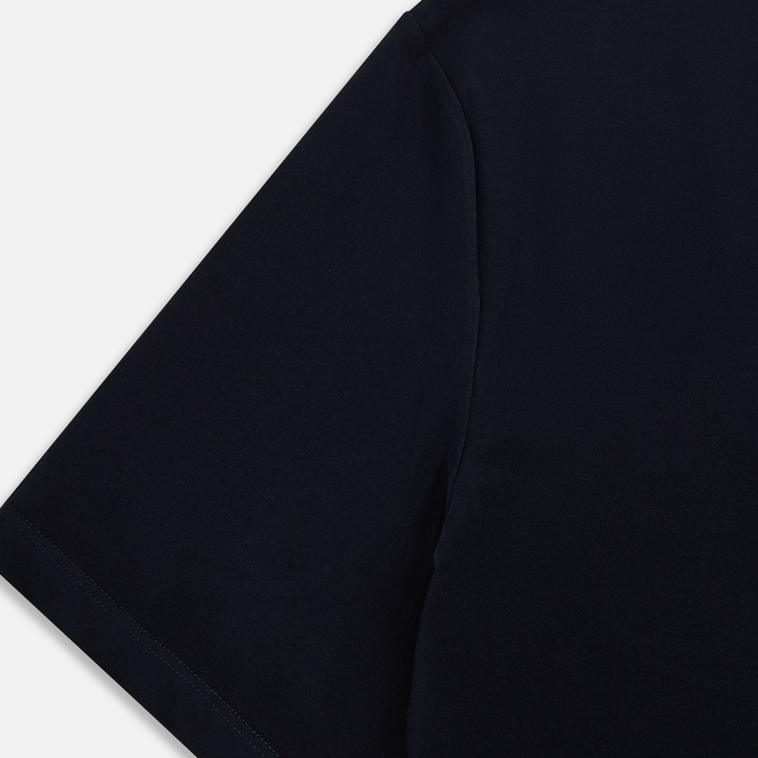 View 4 of product A navy short-sleeve pyjama shirt by Turnbull & Asser is laid flat on a white background, featuring a round neckline and a minimalist design—perfect for relaxed wear.