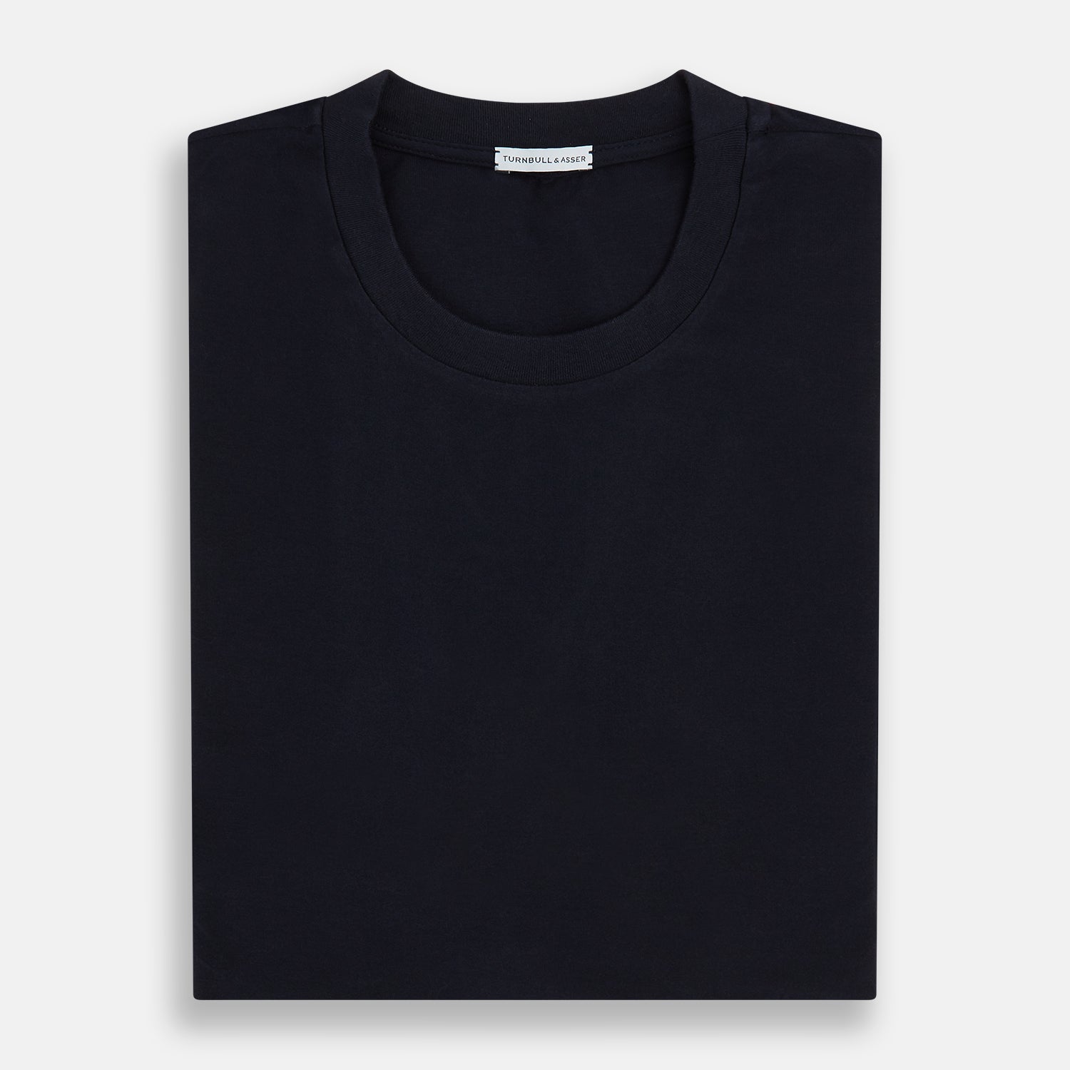 View 5 of product A navy short-sleeve pyjama shirt by Turnbull & Asser is laid flat on a white background, featuring a round neckline and a minimalist design—perfect for relaxed wear.