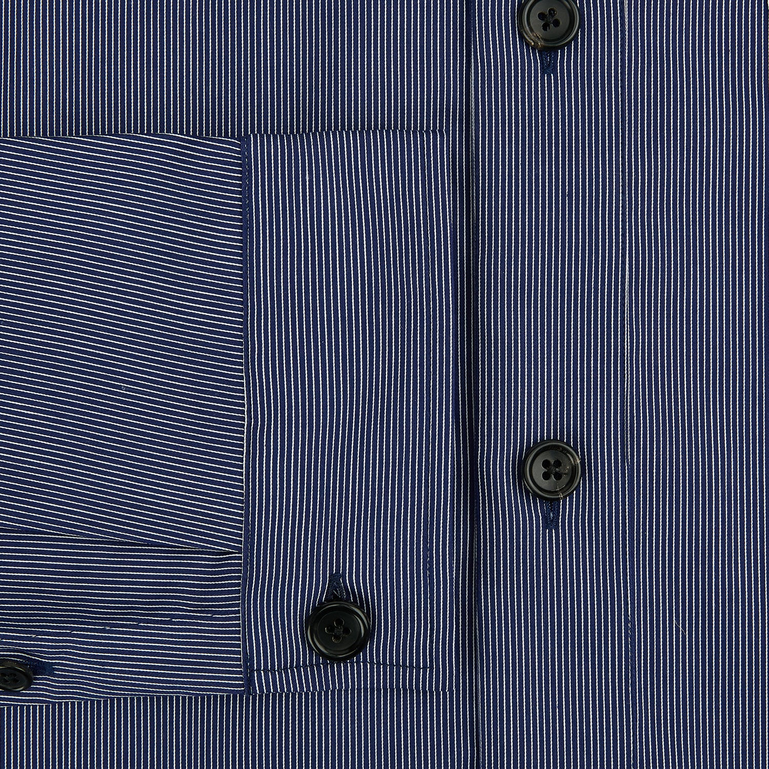 View 4 of product The Navy Stripe Highbury Overshirt by Turnbull & Asser features thin vertical stripes, black buttons, a collar, and a chest pocket. Displayed on a plain white background, it’s inspired by classic Turnbull & Asser style.