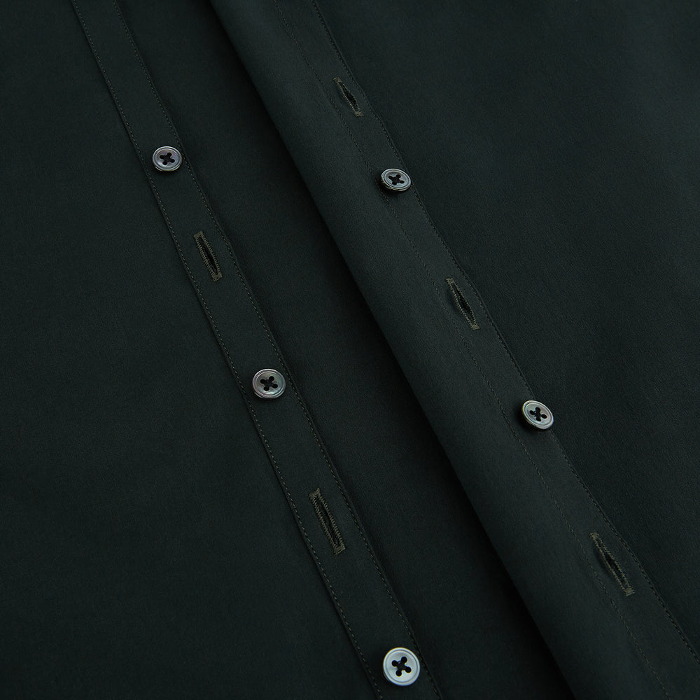 The FOREST GREEN WINDSOR SHIRT by Turnbull & Asser features long sleeves, a Windsor collar, and buttoned cuffs, exemplifying British craftsmanship. Displayed on a plain white background.